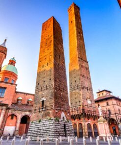 Bologna's famous leaning medieval towers, Asinelli and Garisenda, with the Church of Santi Bartolomeo e Gaetano nearby.