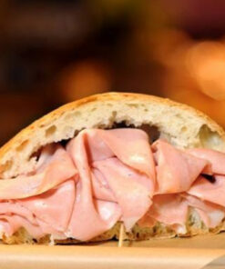 Authentic Italian Mortadella sandwich served on parchment paper, showcasing a Bologna specialty