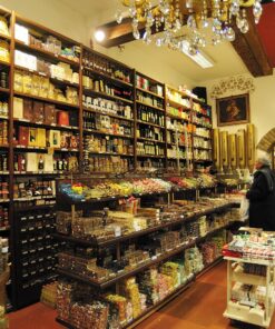 Interior of a historic Bologna gourmet food shop and chocolatier, shelves brimming with local delicacies and sweets.