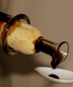 Tasting portions of traditional aged balsamic vinegar on spoons at an acetaia in Modena.