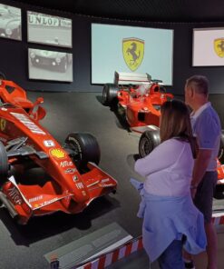 Row of gleaming red Ferrari sports cars at the museum, a stop on the Modena tour
