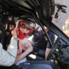 Excited passenger getting ready for hot laps in a Ferrari Challenge car at the Modena circuit.