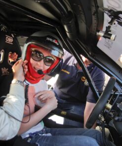 Excited passenger getting ready for hot laps in a Ferrari Challenge car at the Modena circuit.